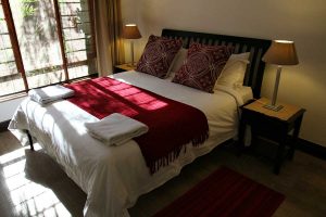 The master bedroom in the Sandton Gateway self-catering apartment in Craighall Park, Johannesburg.