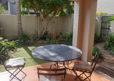 The verandah and private garden in the Sandton Gateway self-catering apartment in Craighall Park, Johannesburg.