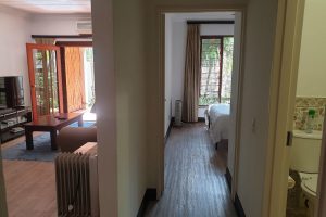 The passage, bathroom, master bedroom and lounge in the Sandton Gateway self-catering apartment in Craighall Park, Johannesburg.