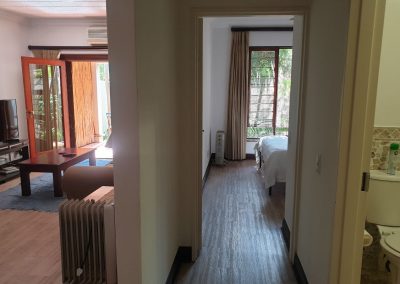 The passage, bathroom, master bedroom and lounge in the Sandton Gateway self-catering apartment in Craighall Park, Johannesburg.