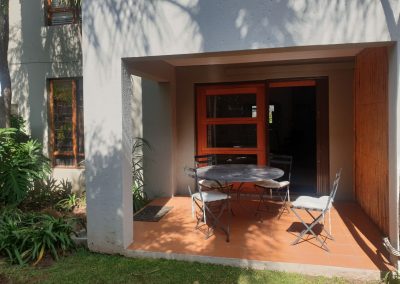 The verandah and lounge from the private garden in the Sandton Gateway self-catering apartment in Craighall Park, Johannesburg.
